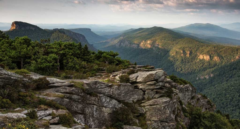 From a high elevation, the vast landscape of the Blue Ridge mountains stretches out for miles. 
